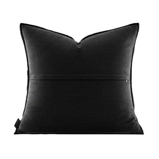 Black pillow with a subtle pattern on a white background