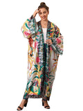 Woman wearing a colorful floral kimono gown with a white background
