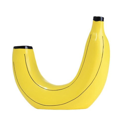 A vibrant yellow vase designed to resemble a ripe banana, with black outlines defining the shape.