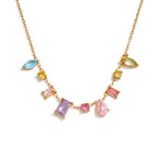 Gold pendant necklace with colorful gemstones on a white background
