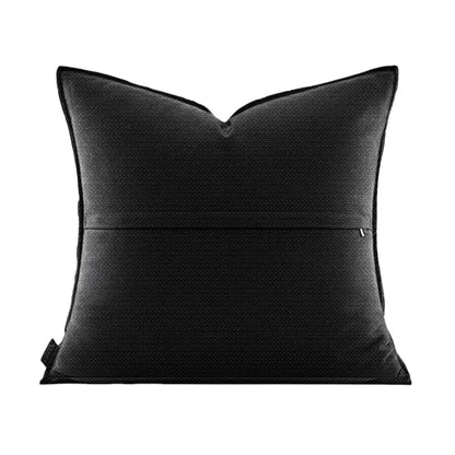 Black pillow with a subtle pattern on a white background