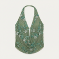 Green floral patterned top on a white background