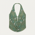 Green floral patterned top on a white background