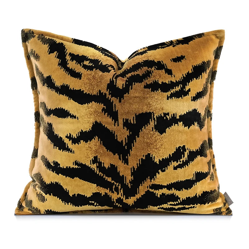 Decorative pillow with black and gold animal tiger-striped pattern on a white background