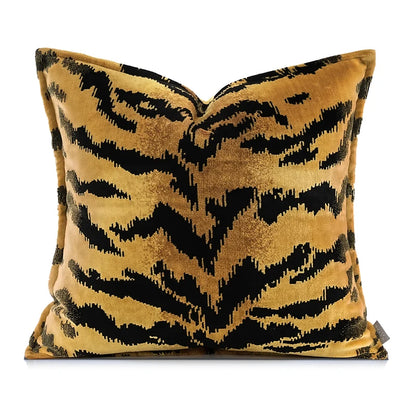 Decorative pillow with black and gold animal tiger-striped pattern on a white background