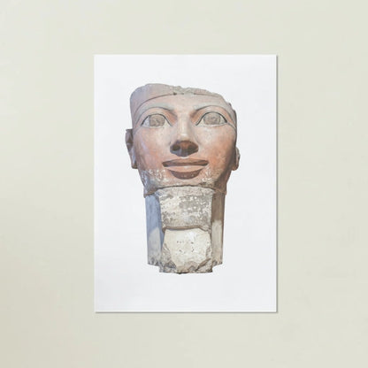 Egyptian stone sculpture of a face on a white background