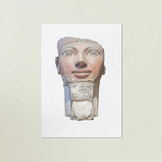 Egyptian stone sculpture of a face on a white background
