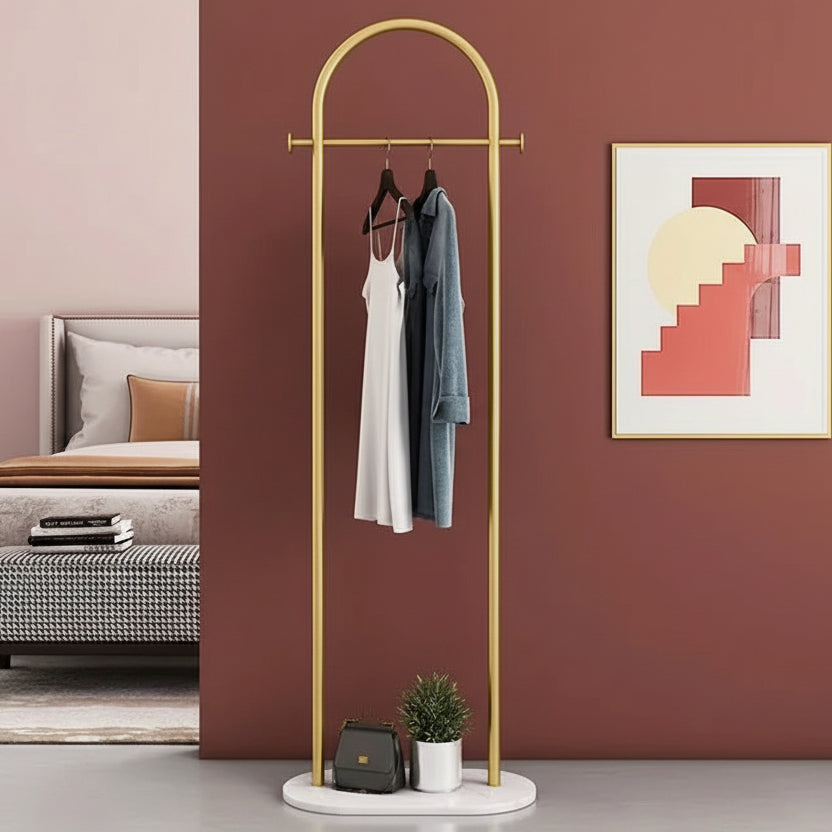 Gold and marble clothing rack, and white dress and blue jacket in a lounge setting