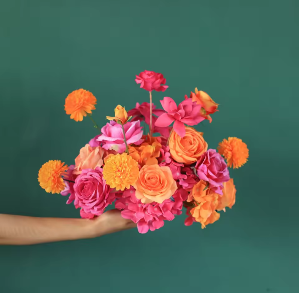 Artificial flower bouquet featuring silk roses, hydrangeas, and marigolds in soft peach tones with sunset vibes. Styled for weddings, home decor, or gifting.