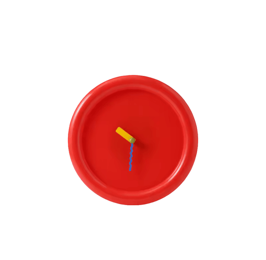 A minimalist round Memphis wall clock in true red color with a yellow minute hand and a blue hour hand, displayed against a white background.