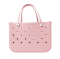 A pink EVA beach tote bag with perforated design and two handles.