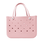 A pink EVA beach tote bag with perforated design and two handles.