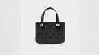 Black waterproof EVA beach bag in a small size, featuring round ventilation holes and two sturdy handles with white button accents, displayed on a white background.
