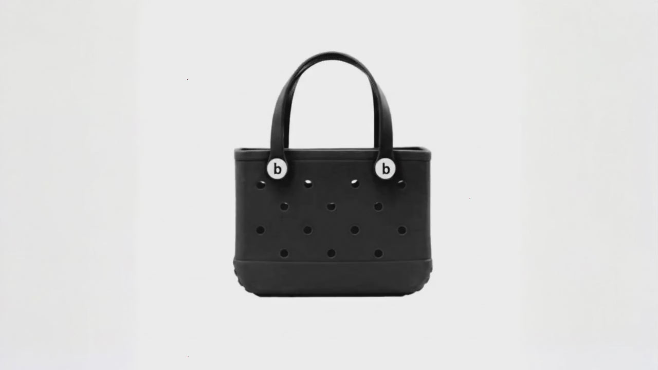 Black waterproof EVA beach bag in a small size, featuring round ventilation holes and two sturdy handles with white button accents, displayed on a white background.