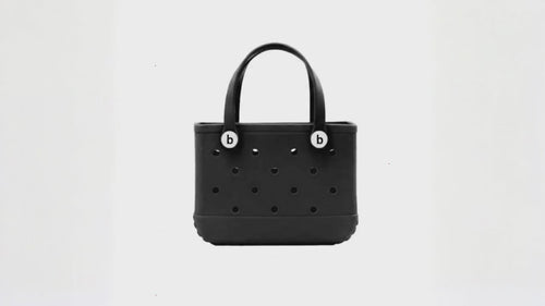 Black waterproof EVA beach bag in a small size, featuring round ventilation holes and two sturdy handles with white button accents, displayed on a white background.