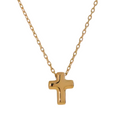 Gold cross necklace on a white background