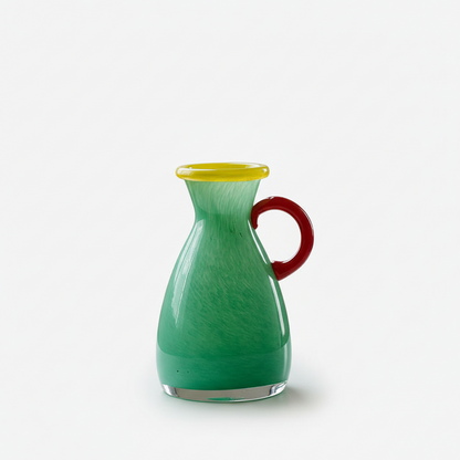 Green glass decorative vase with a red handle on a white background