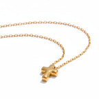 Gold cross necklace on a white background